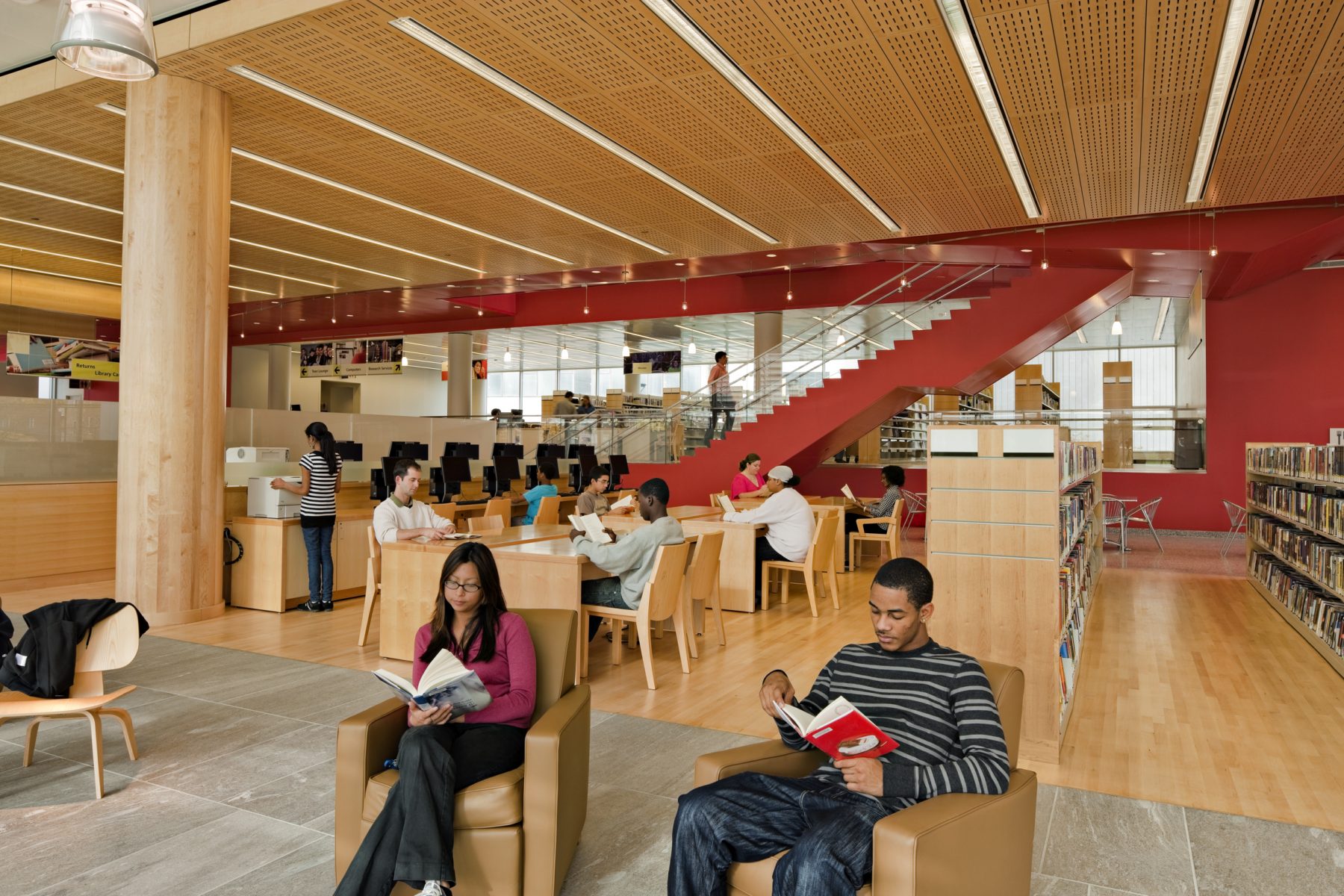 Cambridge Public Library Interior with guests reading at lounge chairs and tables