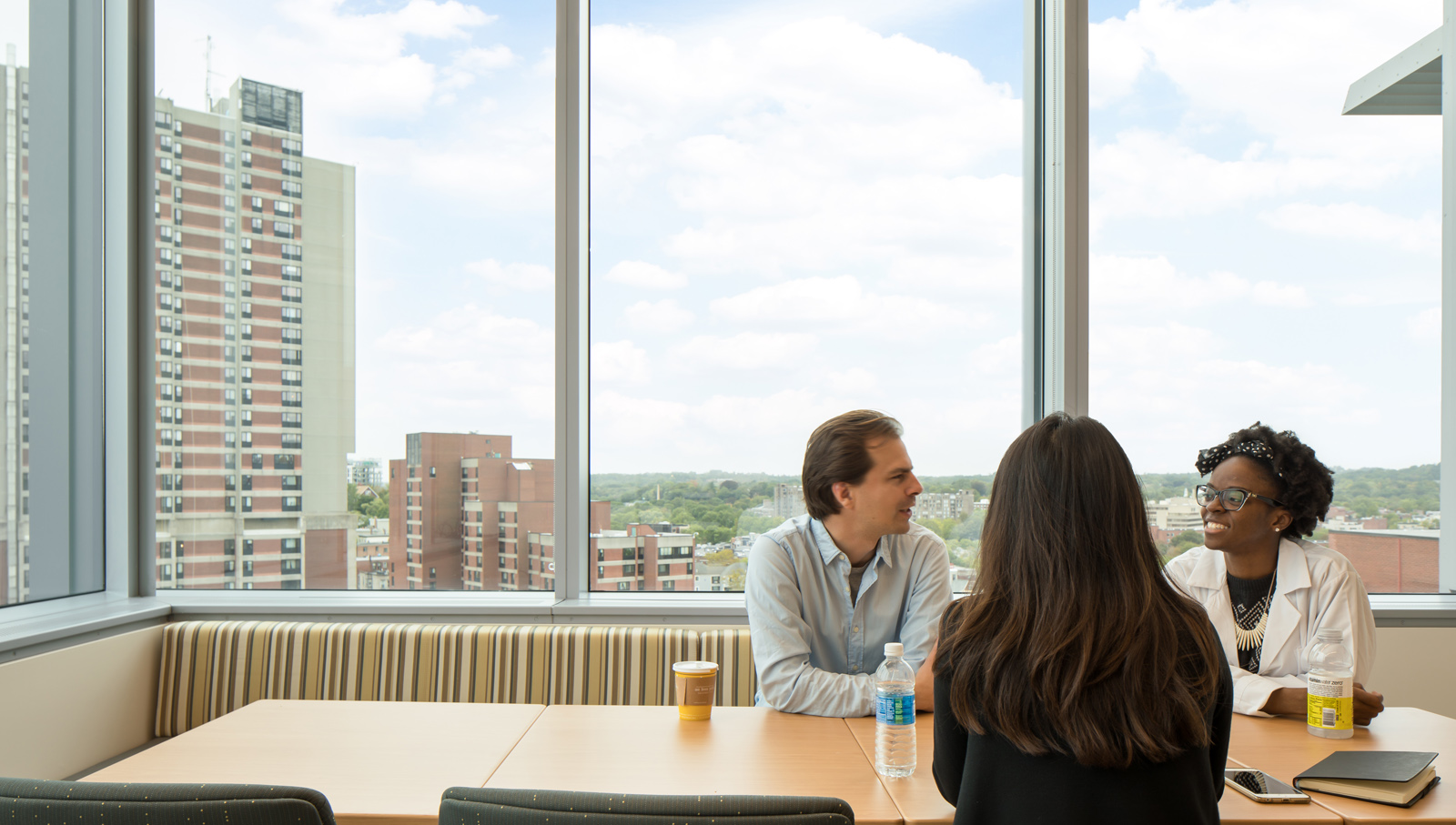 Brigham And Women's Hospital Interior conference room with three people talking around the table