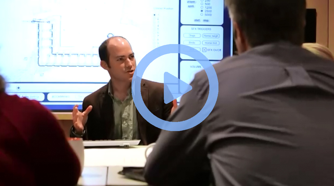 Company culture video thumbnail, men around a conference table..