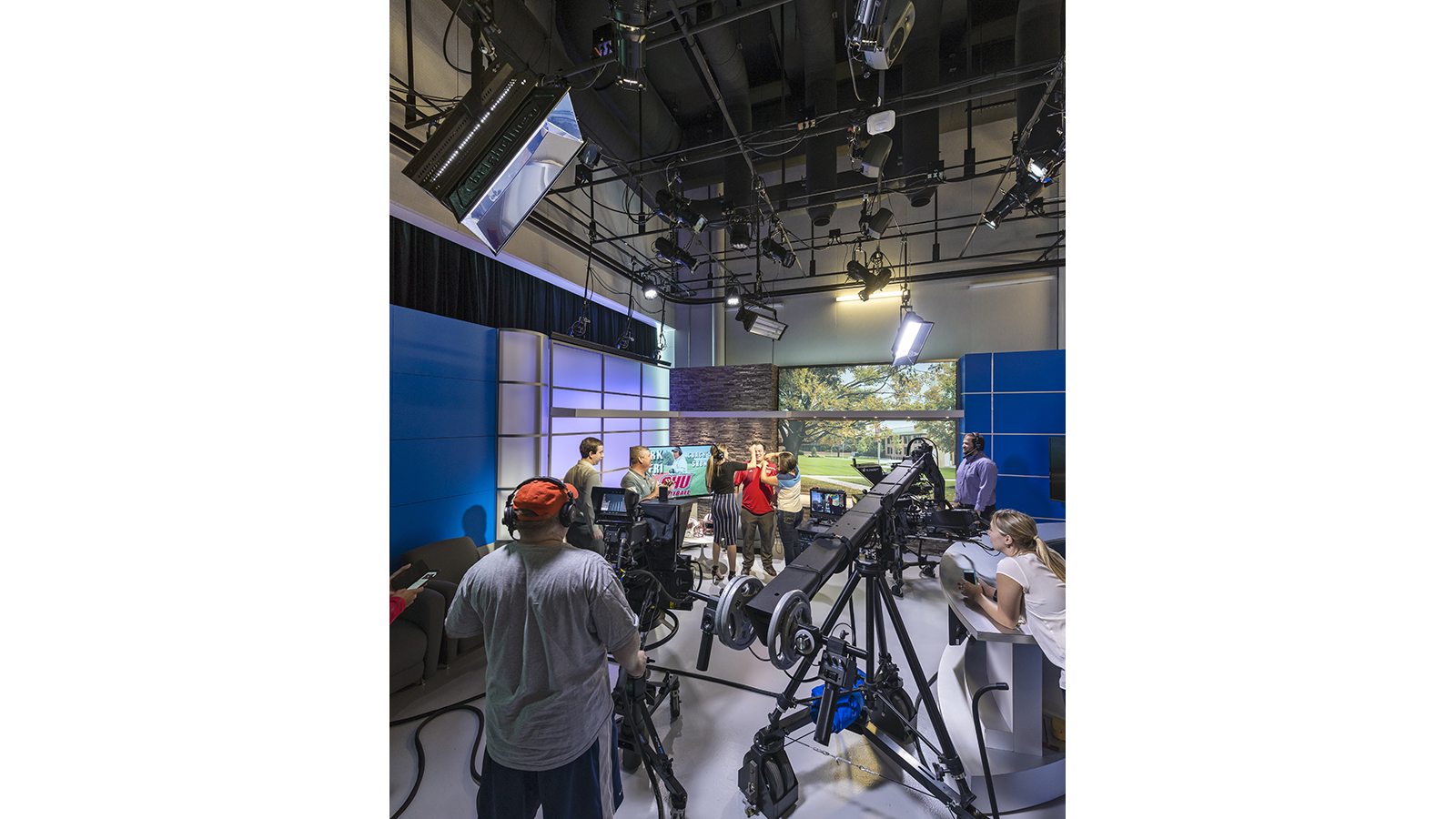 Sacred Heart Martire Center, recording equipment around the room, student receiving last minute makeup touch up, studio lighting