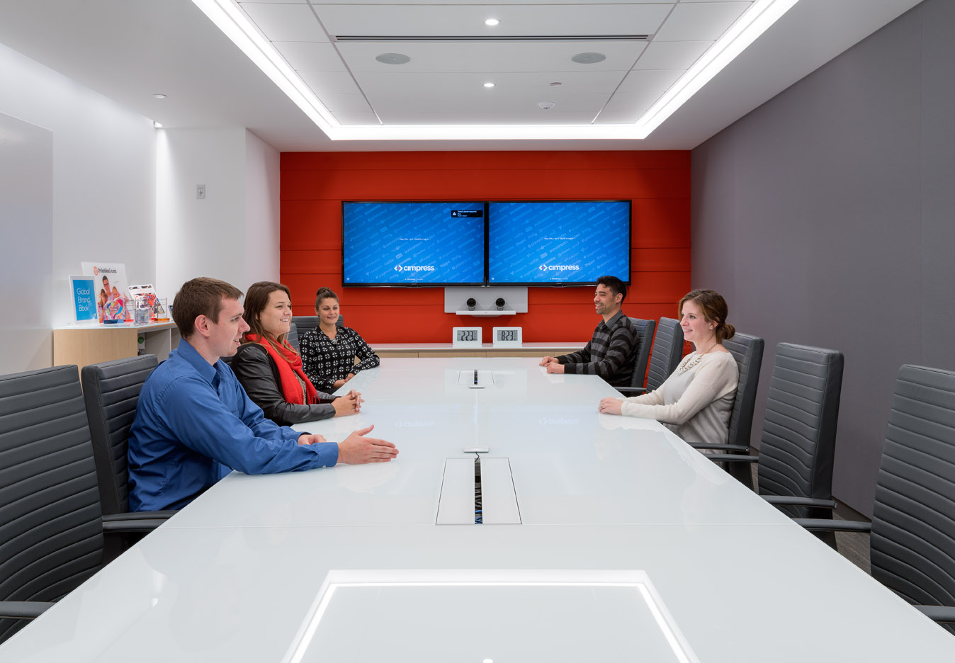 Vistaprint Cimpress Conference Room, 5 employees discuss
