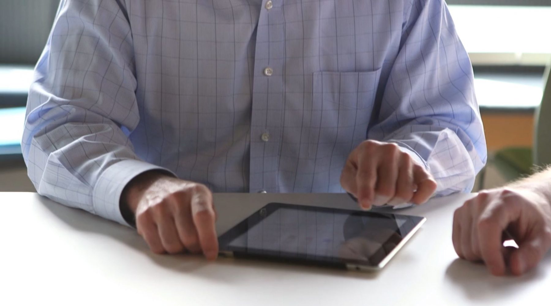 a photo of a man using a tablet