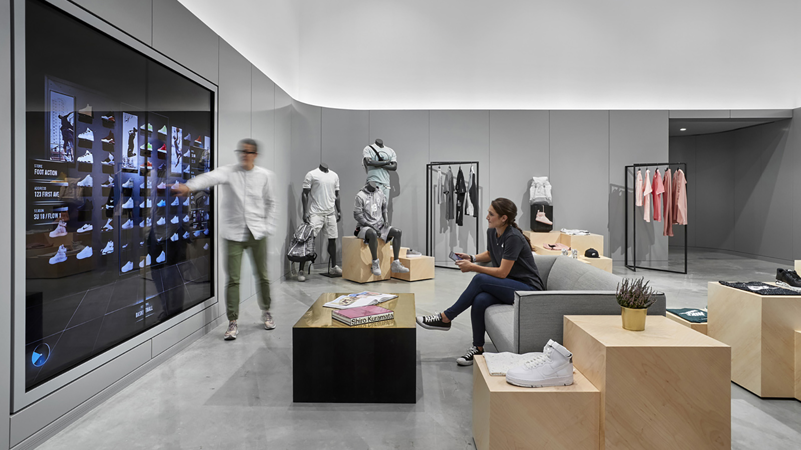 Nike Nyc Headquarters Interior, an employee interacts with a large videowall touch screen