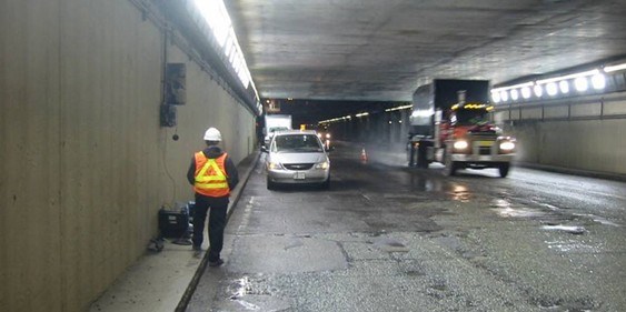 An image of an Acentech Consultant taking measurements in a Highway tunnel