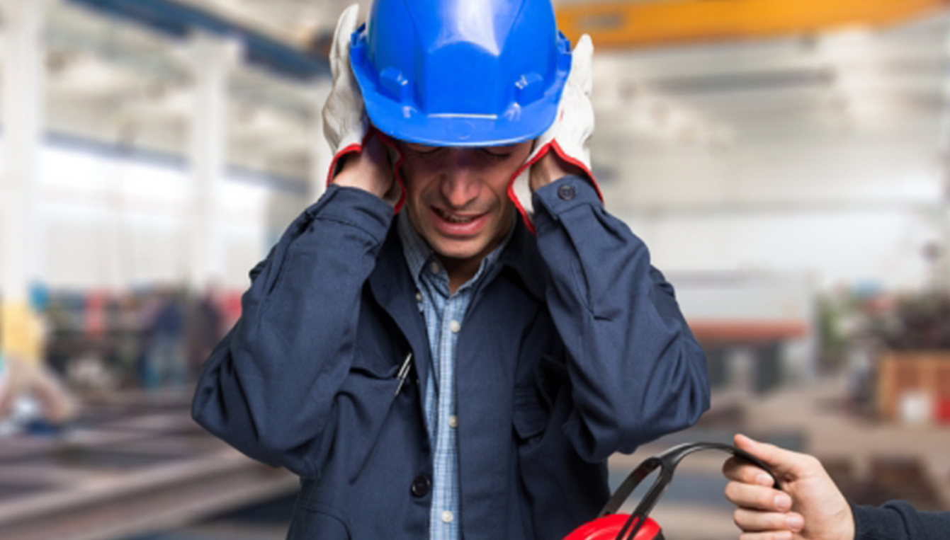 Man In Hard Hat Blocking His Ears