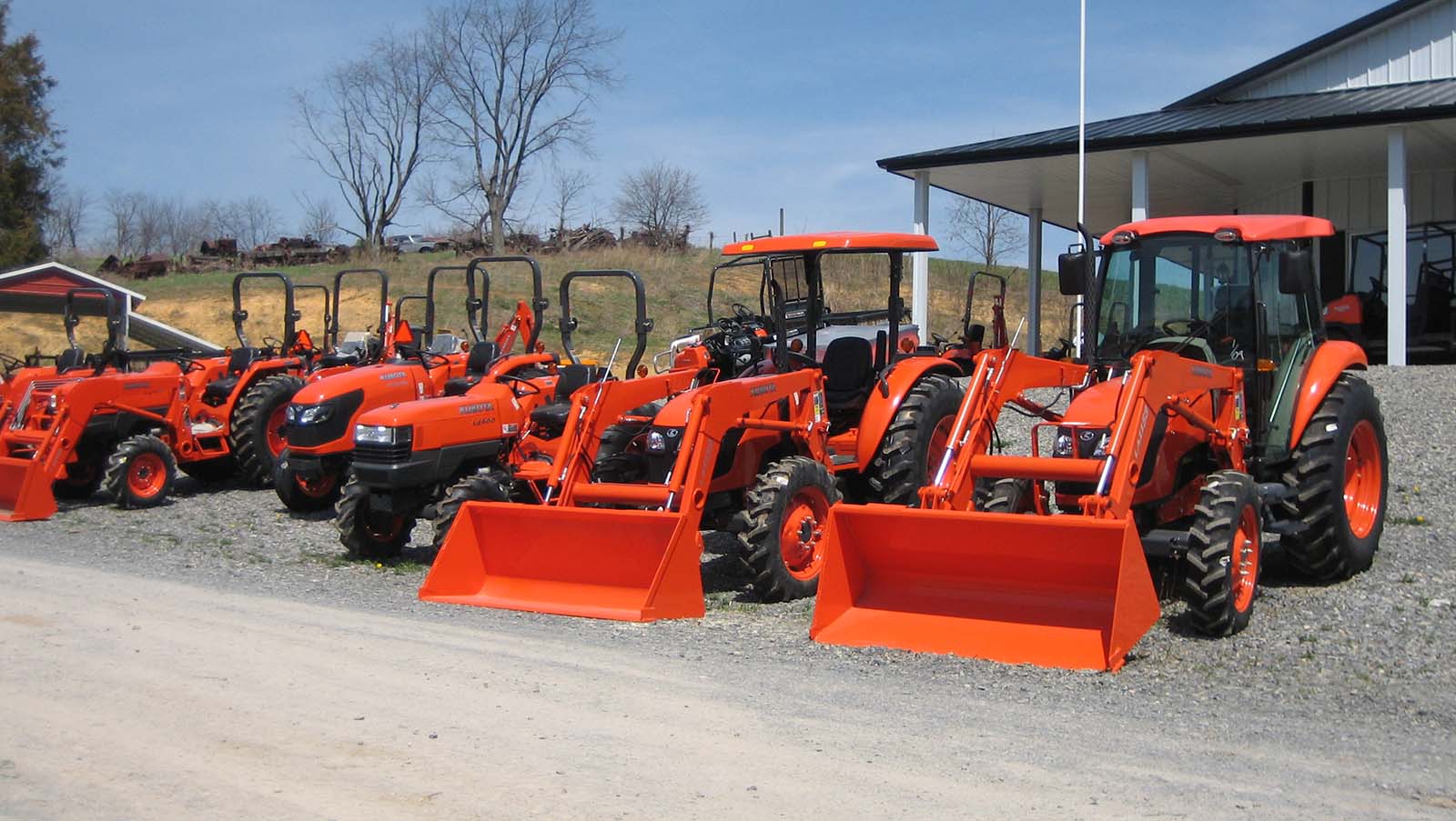 An image of a row of small utility tractors