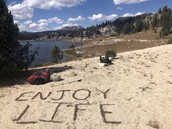 Enjoy life written in the sand