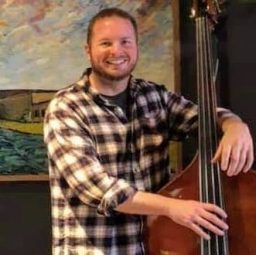 Ken Bourinot smiling while playing Bass