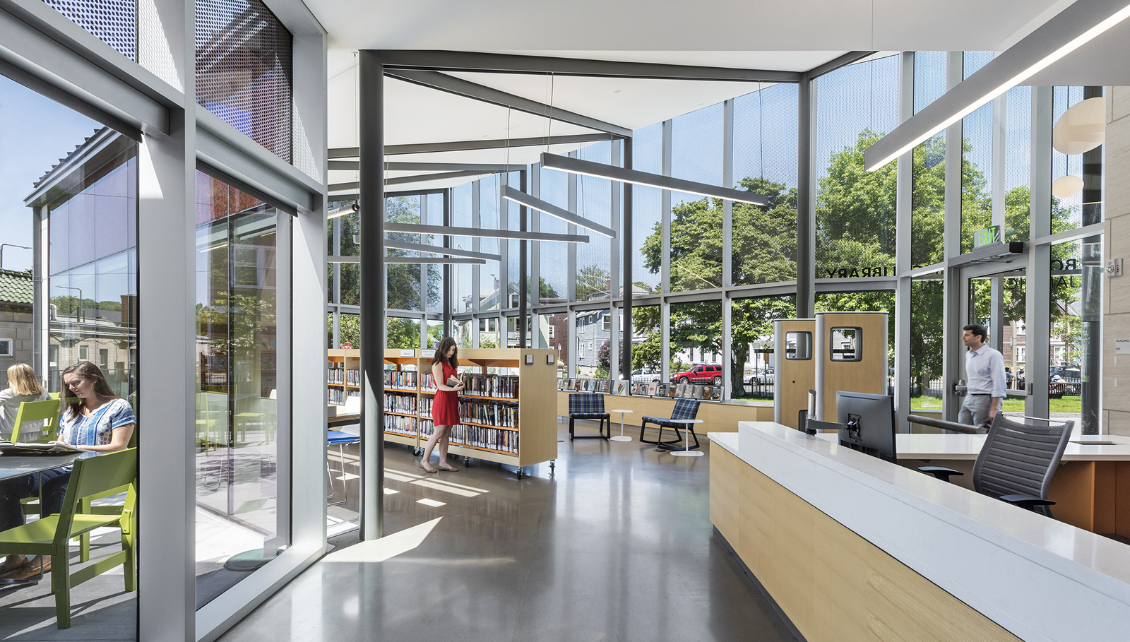 An image of the Boston Public library Jamaica Plain branch front desk and shelves