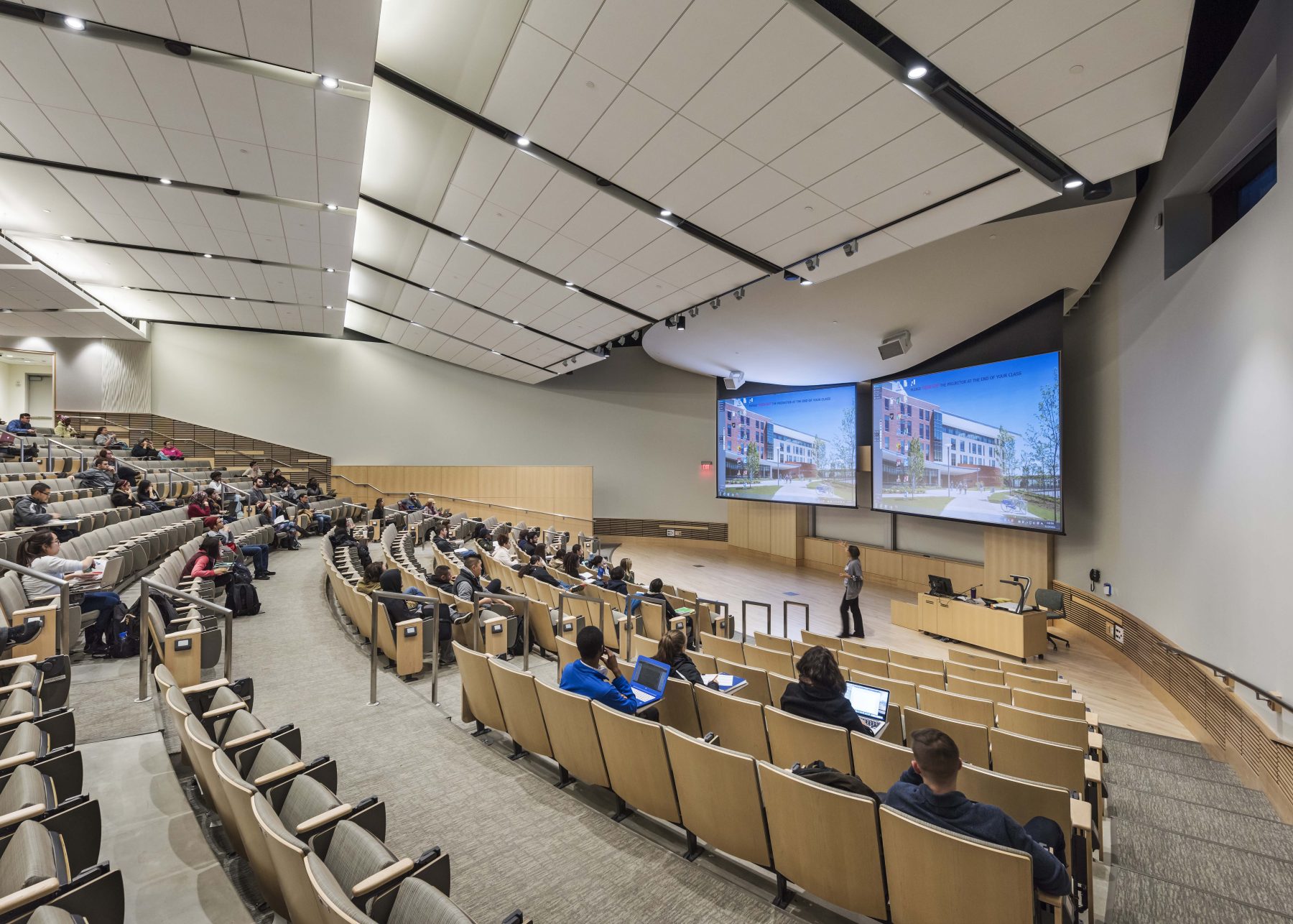 University Hall, University of Massachusetts Boston Higher Education Lecture Hall with two projector screens and plenty of seating.
