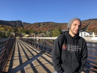 Ethan Casavant on a bridge with hills in the background