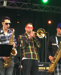 A photo of Colin playing the Trombone on Stage