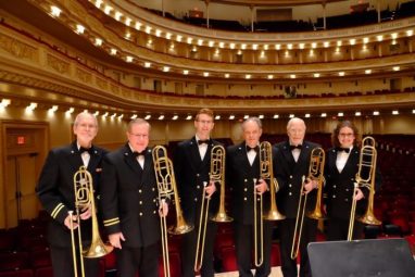A photo of Colin with a trombone group
