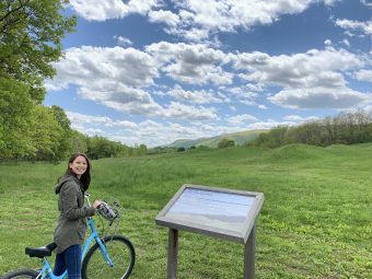Allie Lam biking in green hills