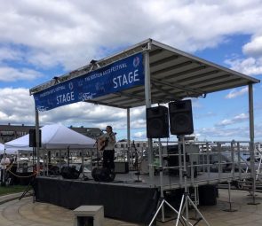 Nicole playing guitar and singing at the Boston Arts Festival