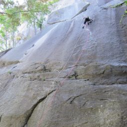 Rose Mary Su Rock Climbing the side of a cliff