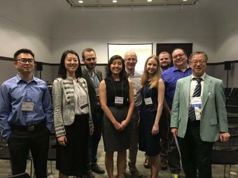 A photo of Sasha and others at a conference