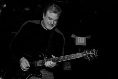 Terrence-Tyson Playing guitar, black and white