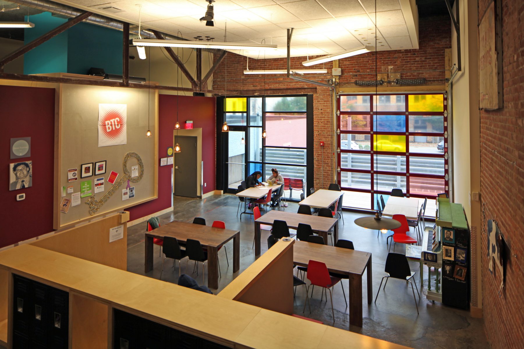 Brookline Teen Center Study Area with red chairs and stained glass panes