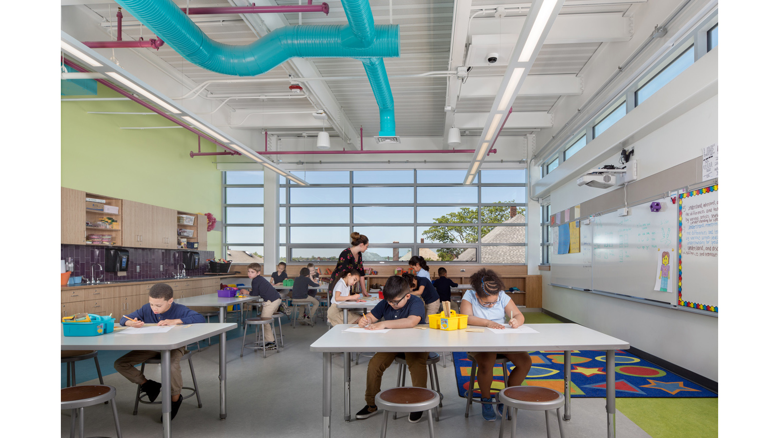 Irwin Jacobs Elementary School Interior, classroom building, colorful HVAC ducts are visible