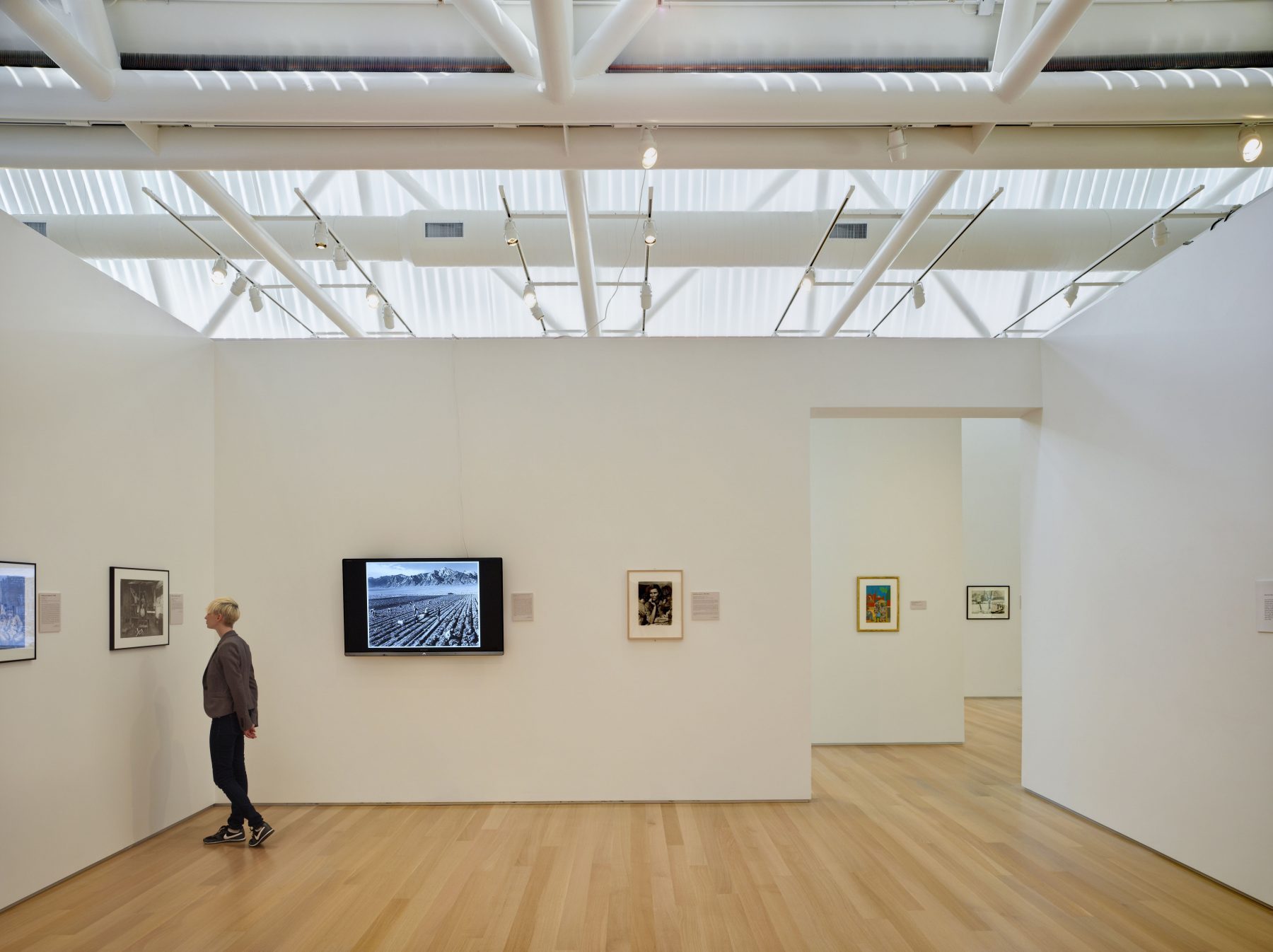 Kenyon Arts Center Art Gallery with a guest inspecting art