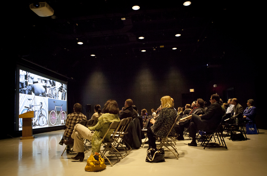 Umaine Wyeth Art Center Auditorium, attendees view a video screen