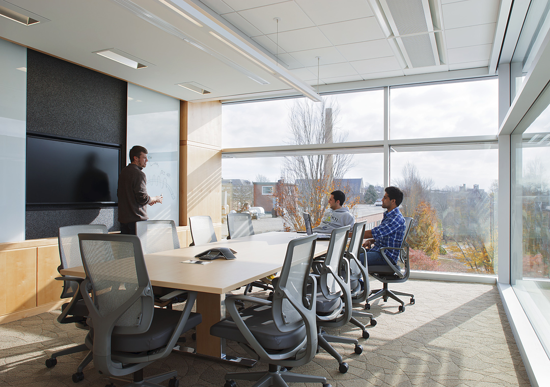 University of Rhode Island College Of Pharmacy Conference Room, two students sit while one presents to them