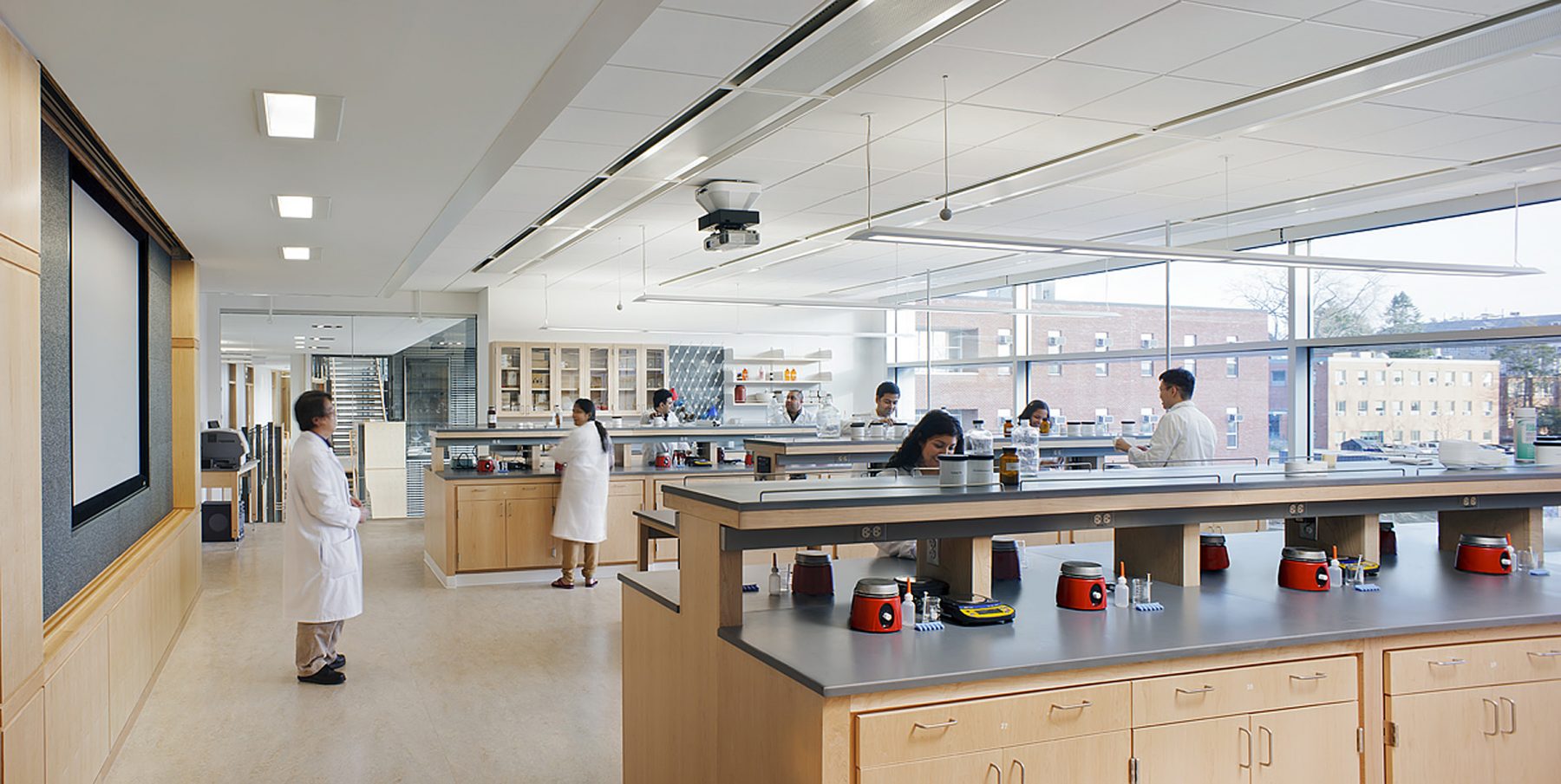 University of Rhode Island College Of Pharmacy Lab with 8 students in lab coats