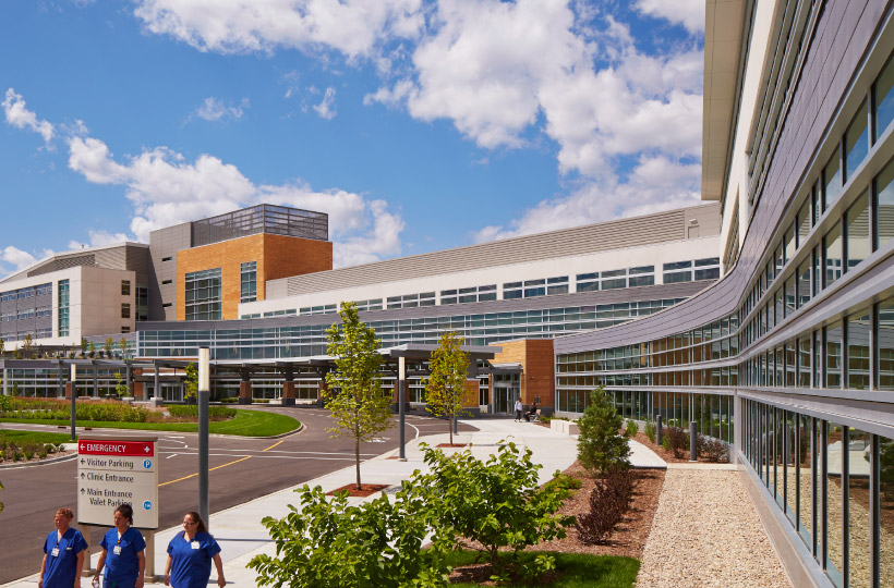 UWHCA at the American Center exterior, nurses walk on the sidwalk