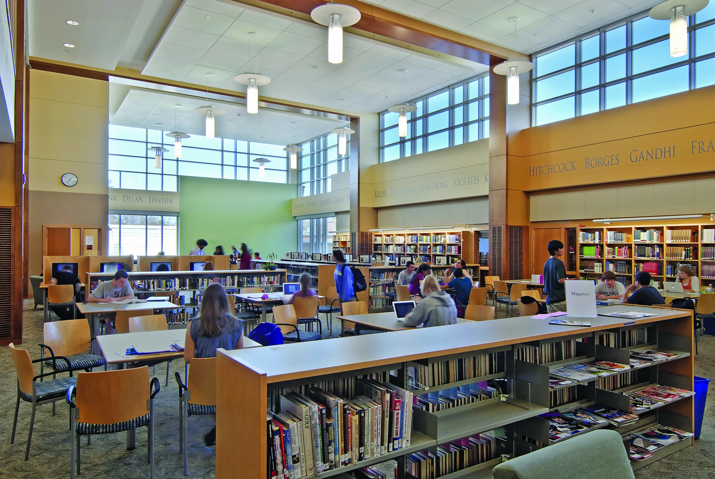 Wellesley High School Library with students using computers and sitting at desks in the common area