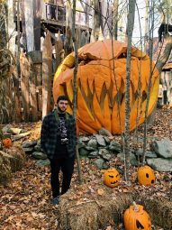 A photo of Joe Barra in front of giant jackolantern