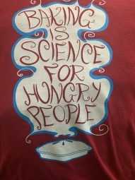 An image of a shirt that says "Baking is Science for Hungry People"