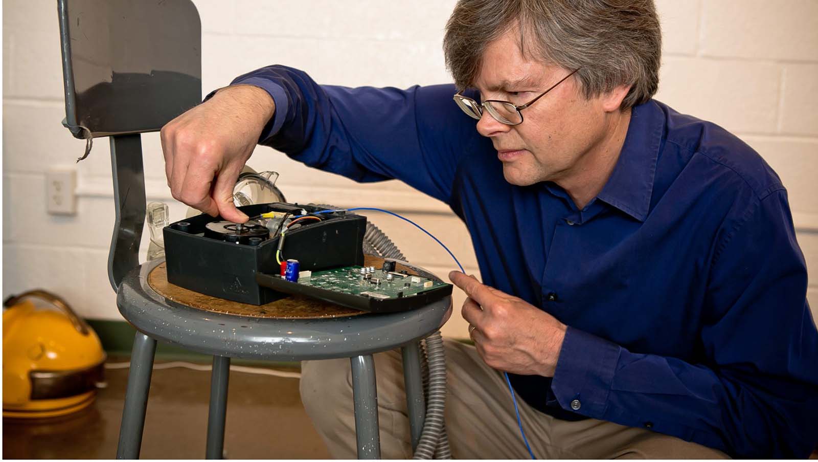 David Bowen works on a disassembled blender