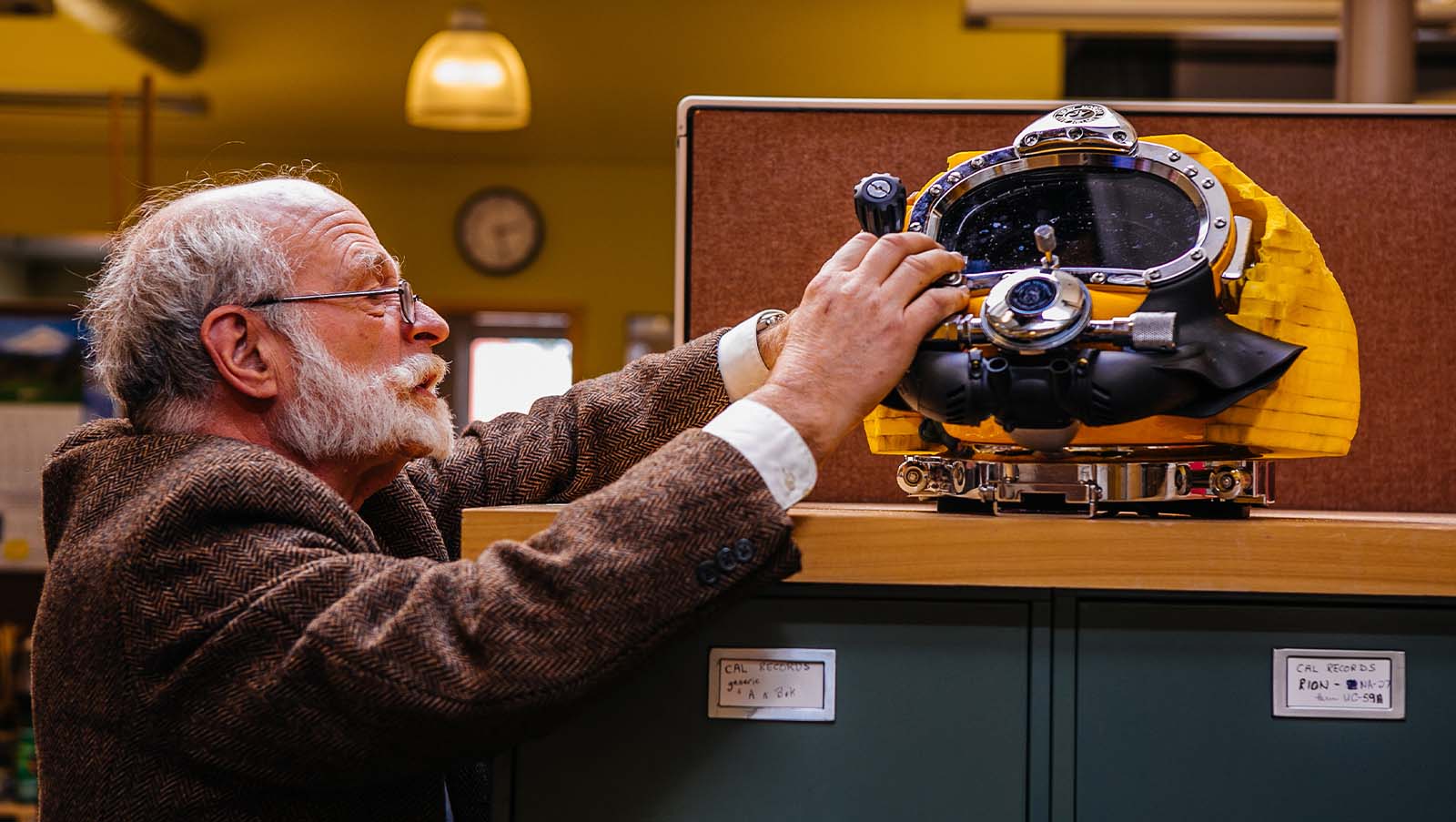 Dive Helmet Noise Reduction, an acoustician secures test materials to the helmet